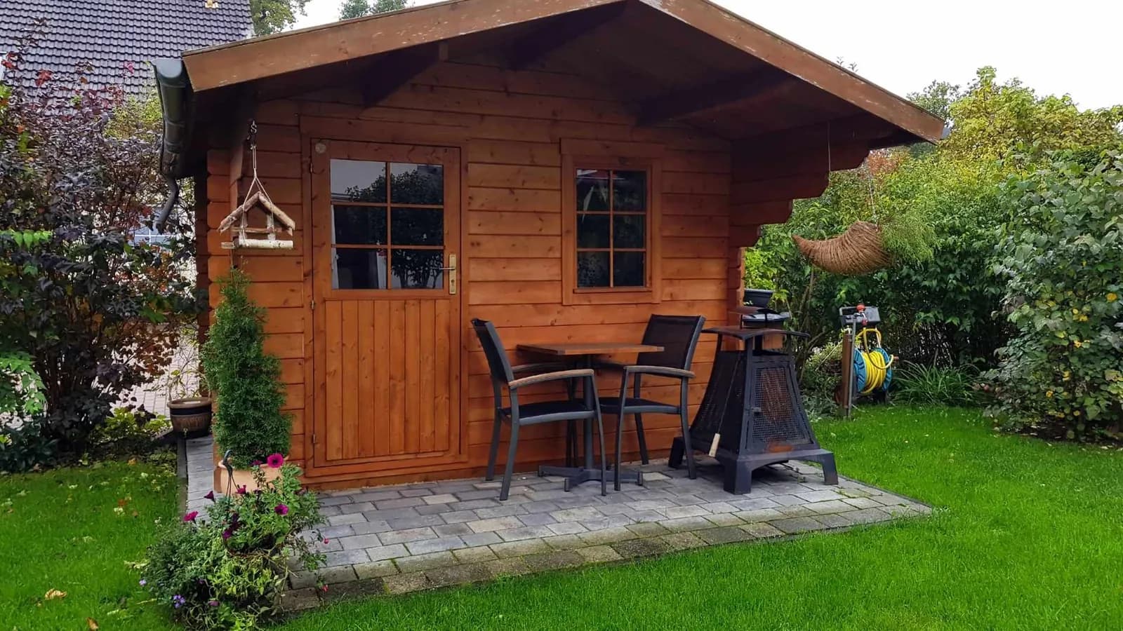 Wooden livable shed with kitchen and bathroom in a residential backyard