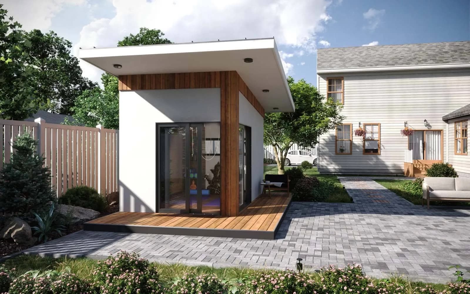 Modern backyard office pod with a deck beside a two-story house