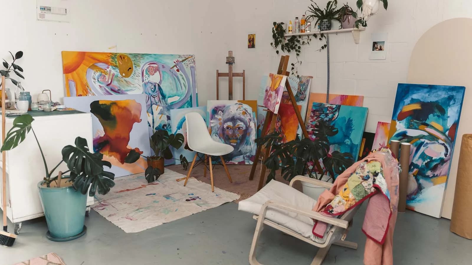 Artist painting in a bright hobby studio with natural light and art supplies