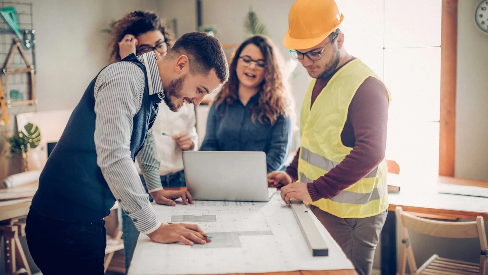 Team gathered around a table for a pre-construction meeting before the project begins