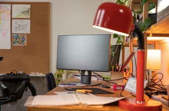 Red desk lamp on a home office desk