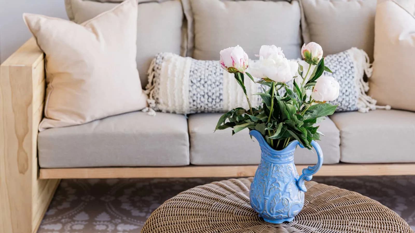 Cozy ADU living room interior with a sofa and a vase of peonies