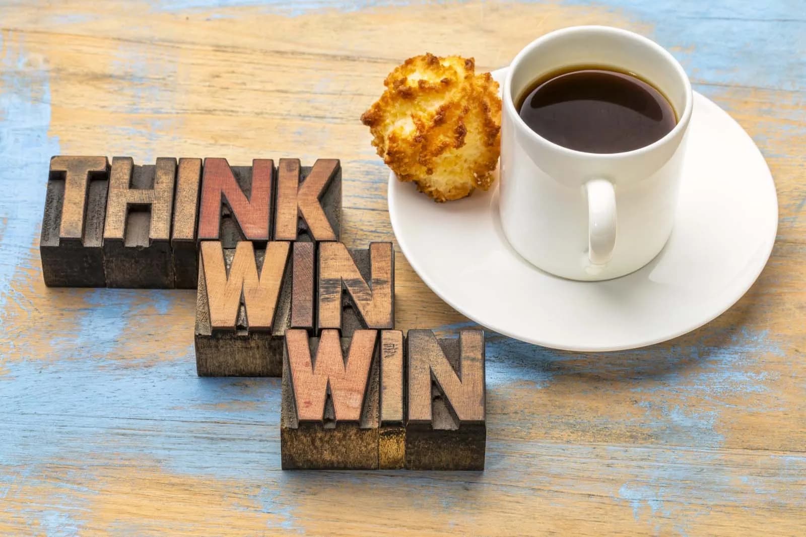 Think Win-Win sign with a cup of coffee