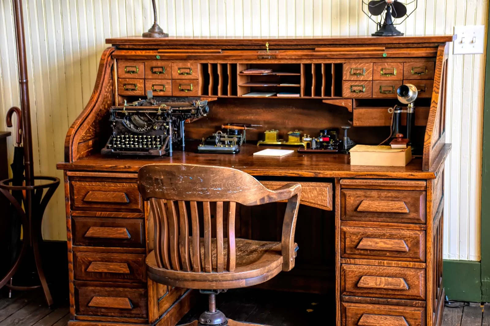 Vintage home office with hardwood floors and classic furniture