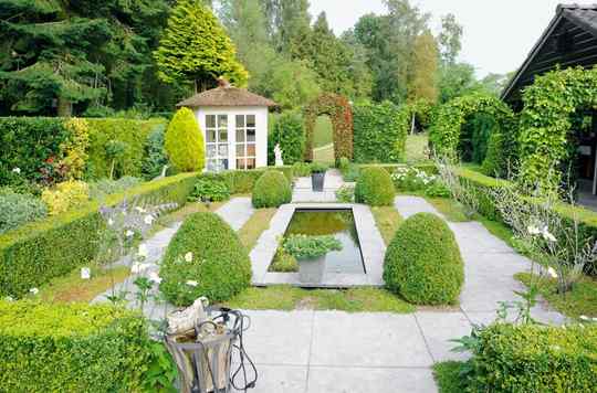 A gazebo in a landscaped backyard