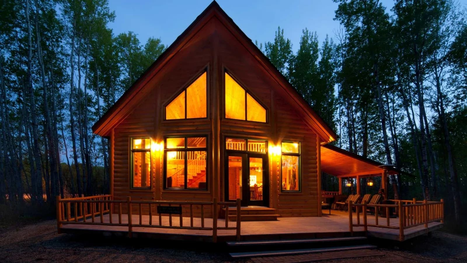 Backyard cabin with a deck and patio