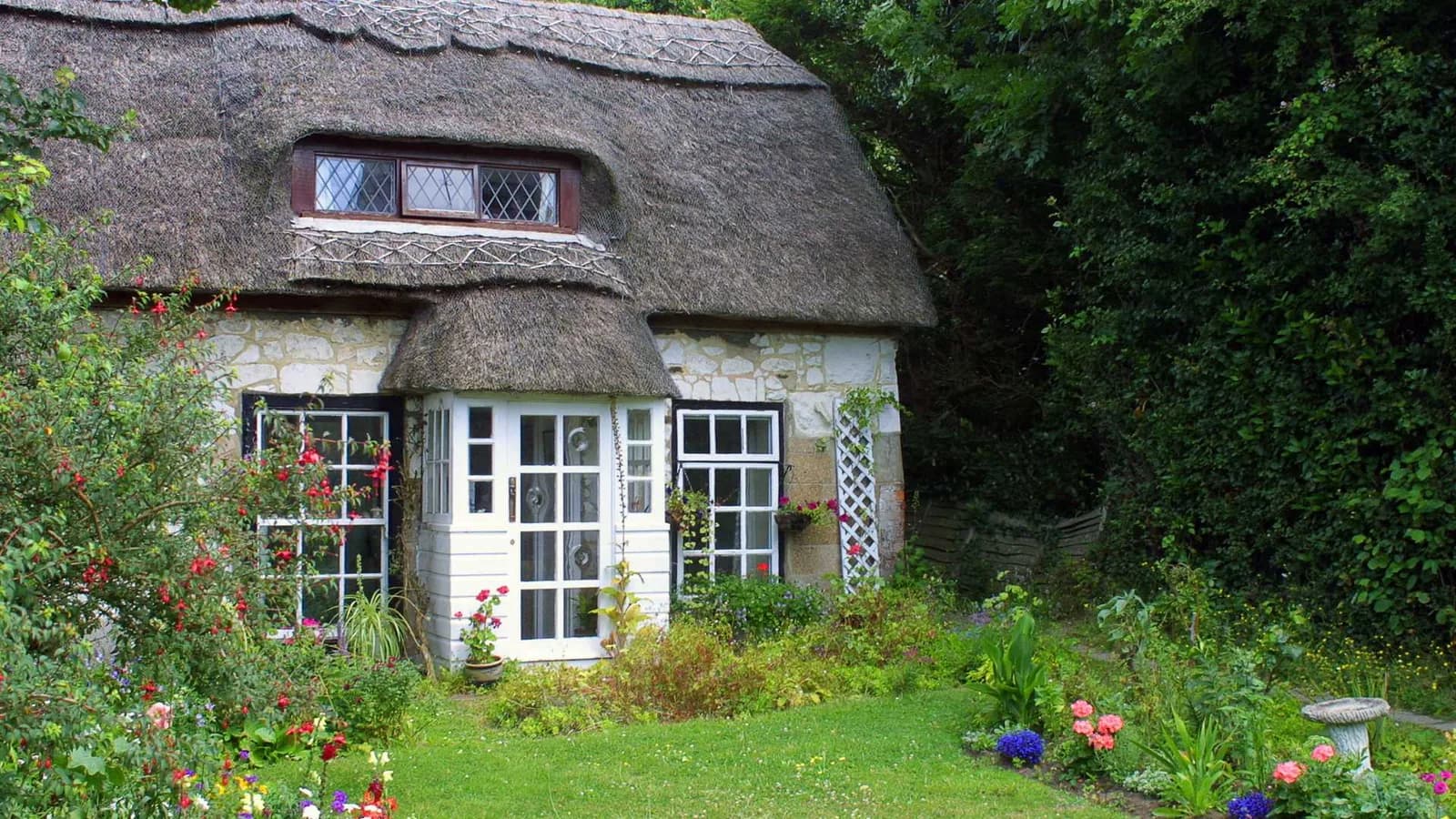 Old-style English cottage with rustic roof