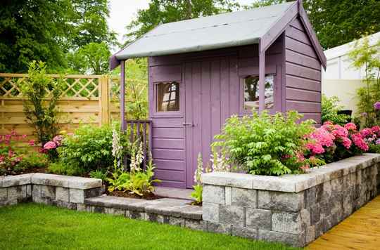 A she-shed with a backyard dining area