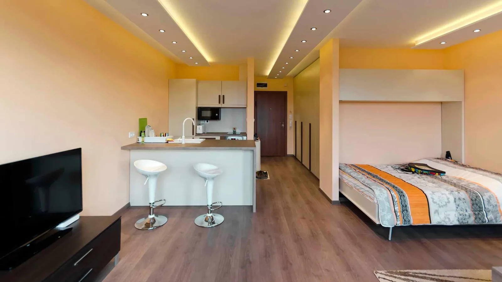 Studio ADU interior with yellow wall accents